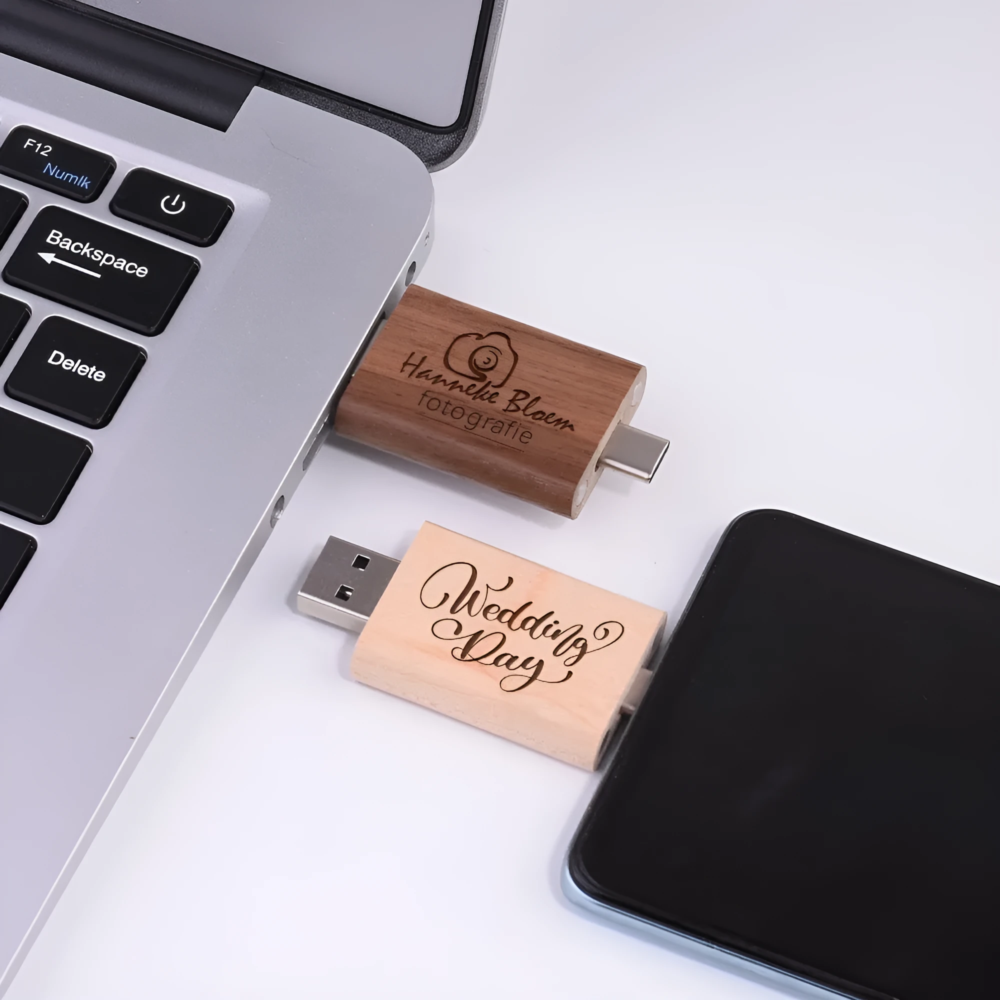 Custom engraved maple wood USB flash drive with Type-C connector for mobile phones on a wooden box.