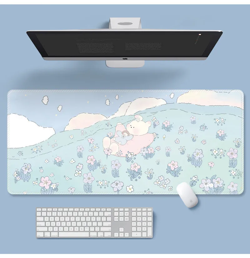 Large colourful flower pattern mouse pad on a wooden desk with keyboard and mouse.