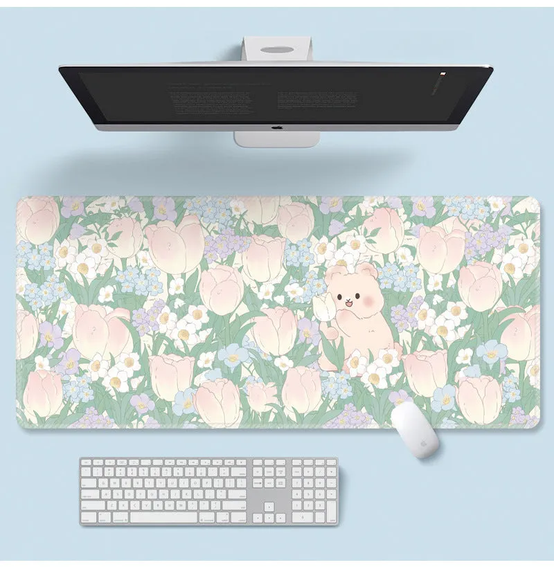 Large colourful flower pattern mouse pad on a wooden desk with keyboard and mouse.