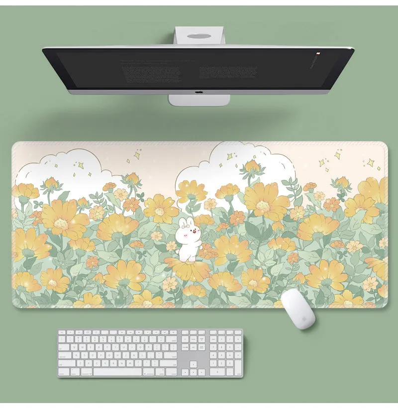 Large colourful flower pattern mouse pad on a wooden desk with keyboard and mouse.