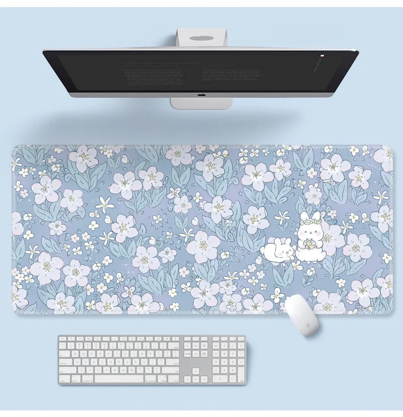 Large colourful flower pattern mouse pad on a wooden desk with keyboard and mouse.