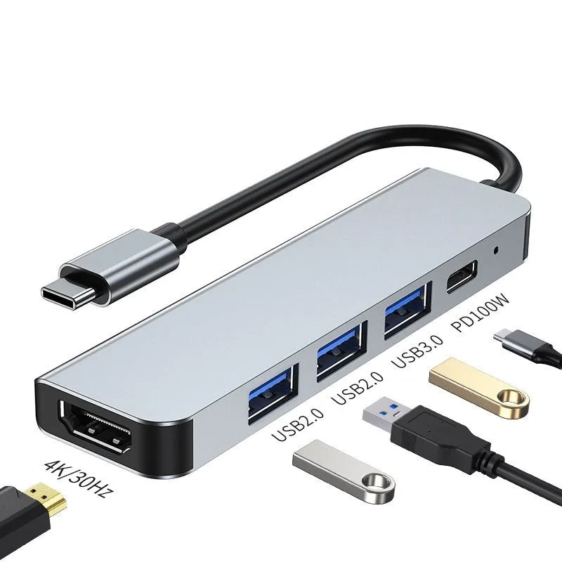 Silver aluminium USB-C expansion dock showing six ports including HDMI, USB 3.0, USB-C PD charging, and card readers