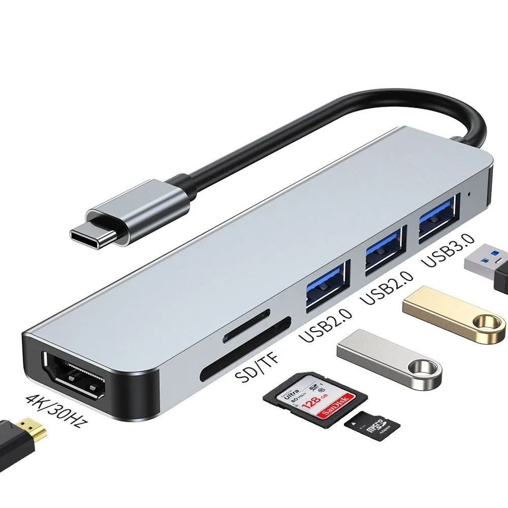 Silver aluminium USB-C expansion dock showing six ports including HDMI, USB 3.0, USB-C PD charging, and card readers