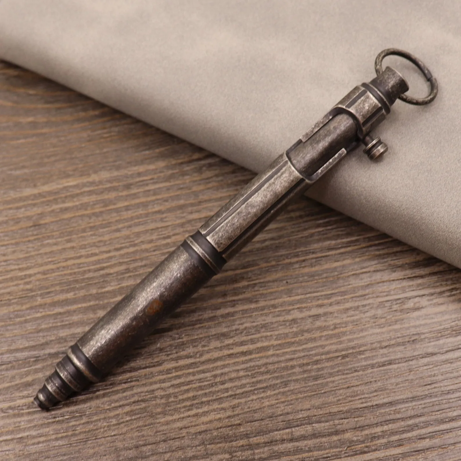 Brass tactical pen with six-ring press mechanism and cylindrical design in metallic finish