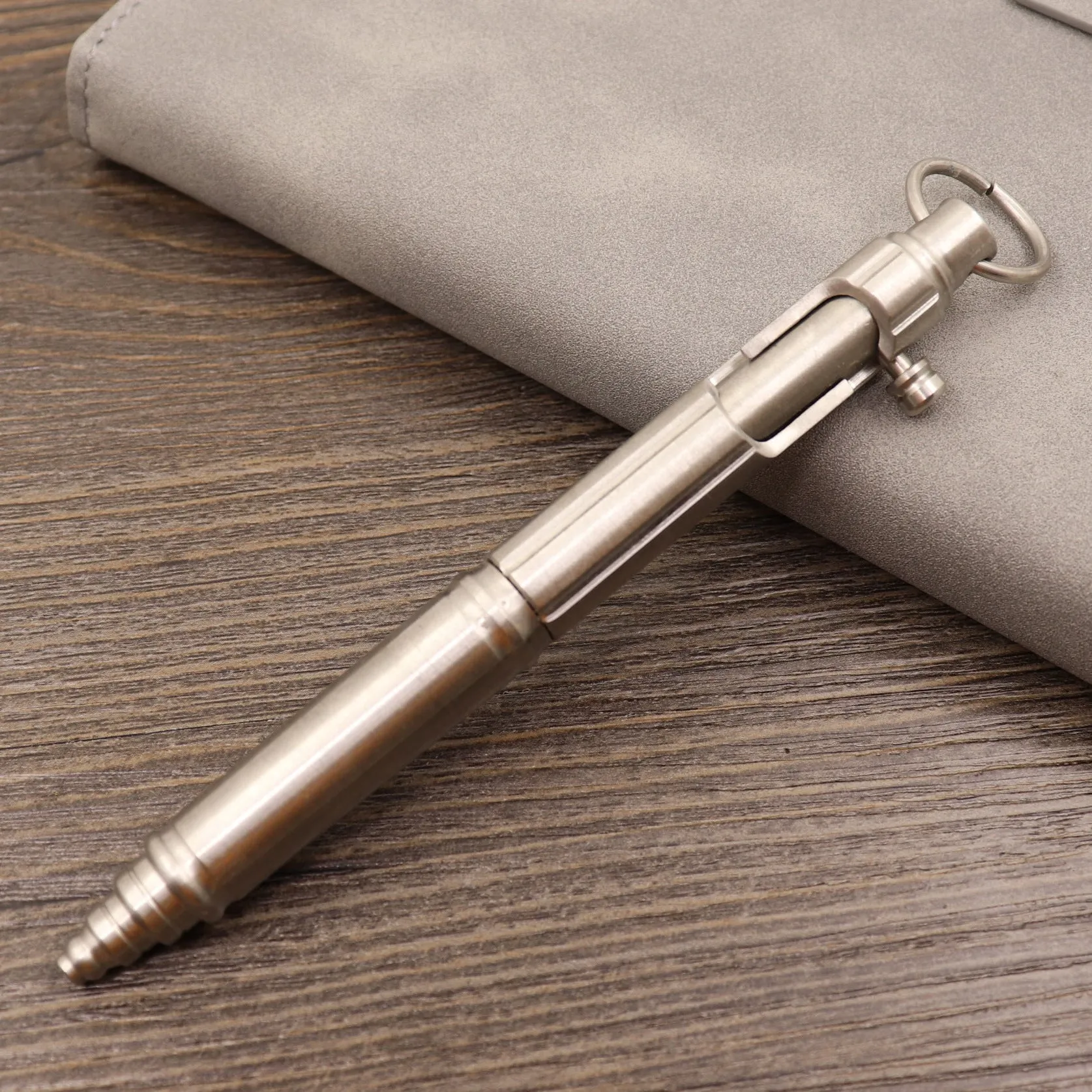 Brass tactical pen with six-ring press mechanism and cylindrical design in metallic finish