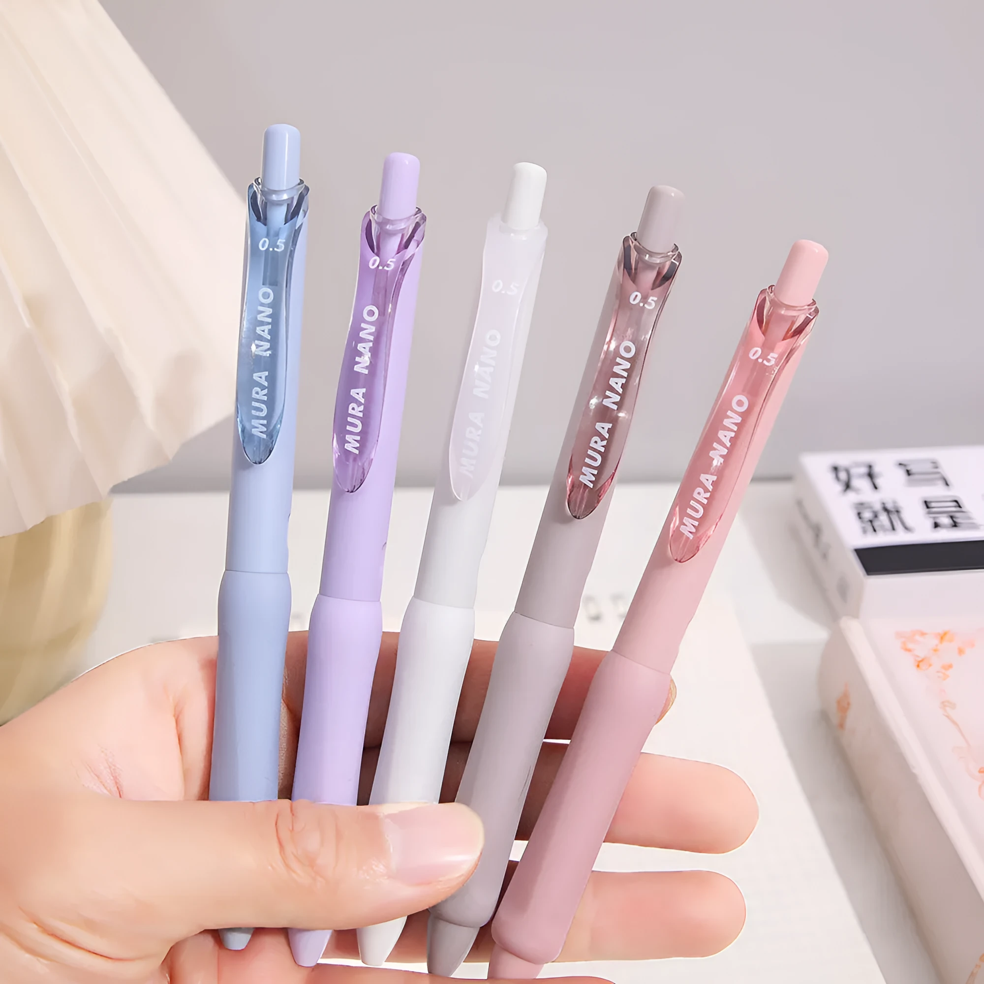 Three macaron-coloured clicker gel pens with 0.5mm fine tips in smoked white, brown, and pink shades