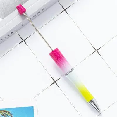 Colourful spinning ballpoint pen with plastic beads on a white background.