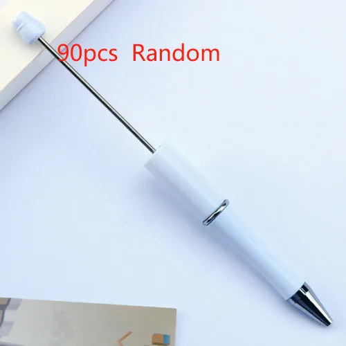 Colourful spinning ballpoint pen with plastic beads on a white background.