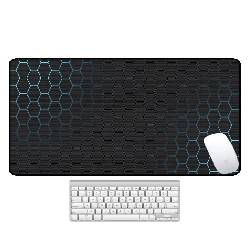 Large printed desk mouse pad with natural rubber non-slip base, shown on a wooden desk.