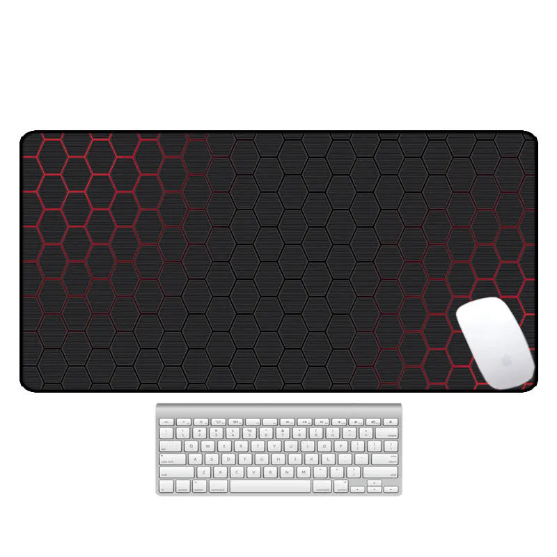 Large printed desk mouse pad with natural rubber non-slip base, shown on a wooden desk.