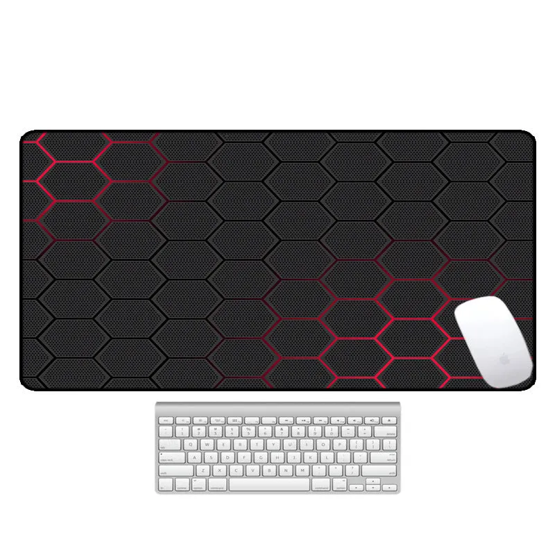 Large printed desk mouse pad with natural rubber non-slip base, shown on a wooden desk.
