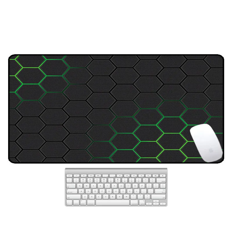 Large printed desk mouse pad with natural rubber non-slip base, shown on a wooden desk.