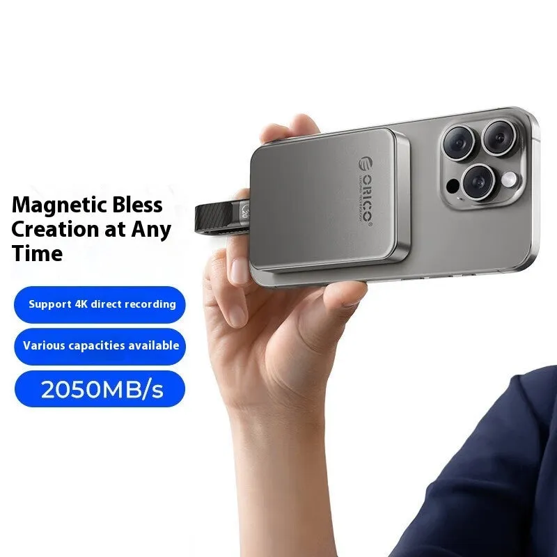 Grey magnetic mobile solid state drive with ultra-thin design next to its C to C cable and magnetic suction ring.