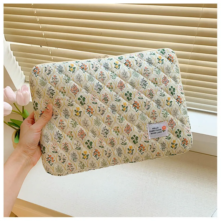 Women's printed floral cloth laptop bag shown in green flower pattern, available in small, medium, and large sizes.