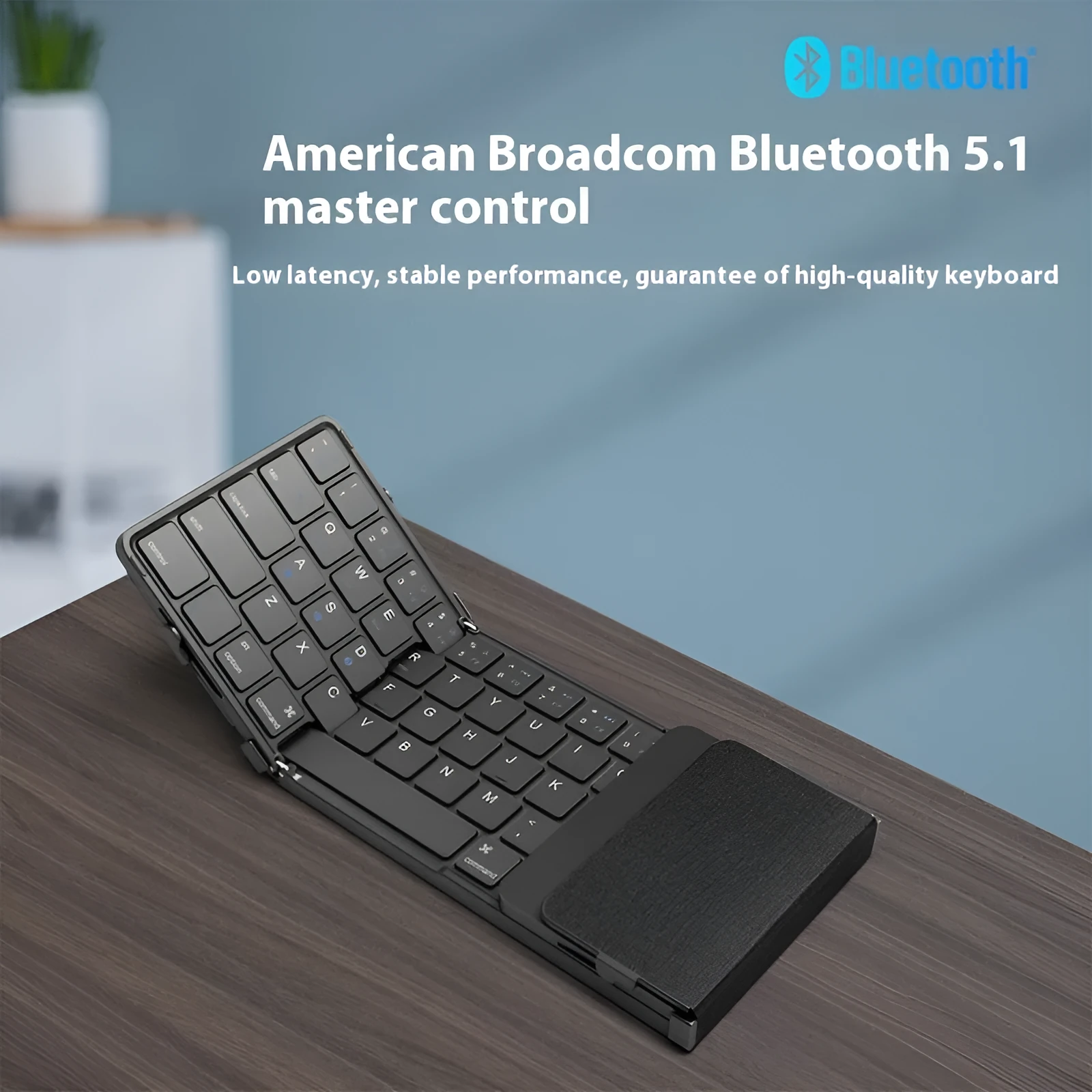 Black folding Bluetooth keyboard for mobile phones and tablets shown in open and closed positions