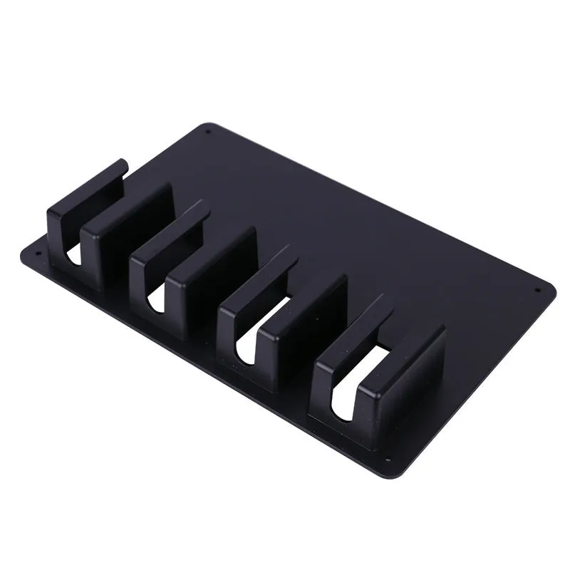 Black plastic wall-mounted rack holding four electric hair clippers.