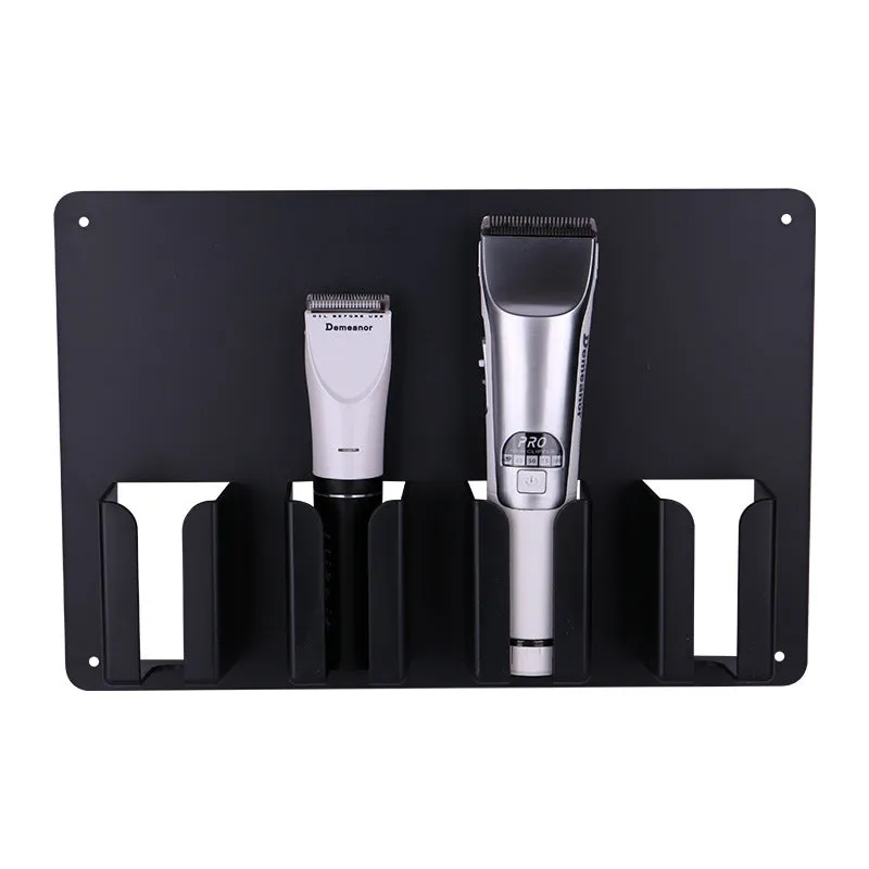 Black plastic wall-mounted rack holding four electric hair clippers.