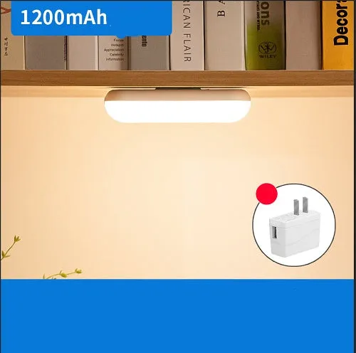 Compact white magnetic LED desk lamp with touch dimming on a wooden desk.
