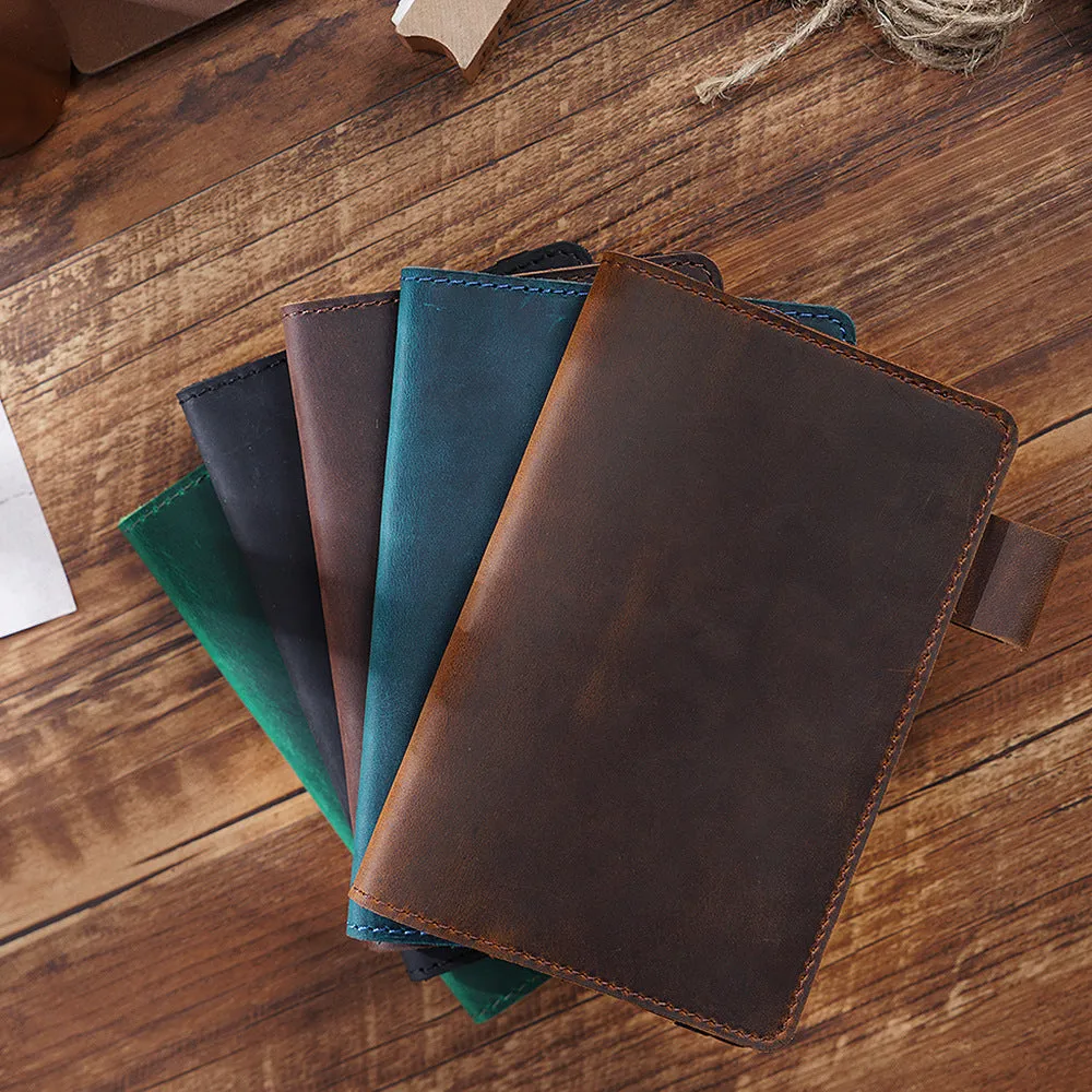 Handmade leather kraft notebook open showing wood-free paper with dark green cowhide cover