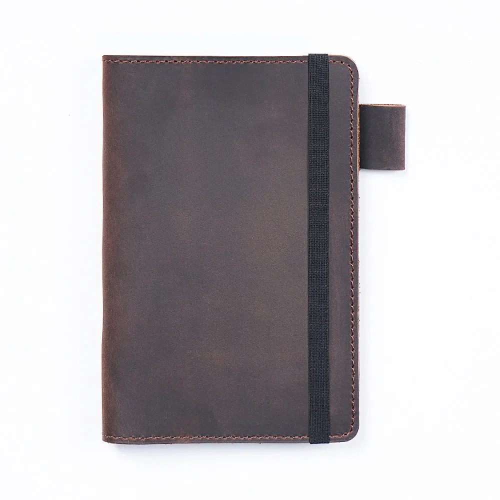 Handmade leather kraft notebook open showing wood-free paper with dark green cowhide cover