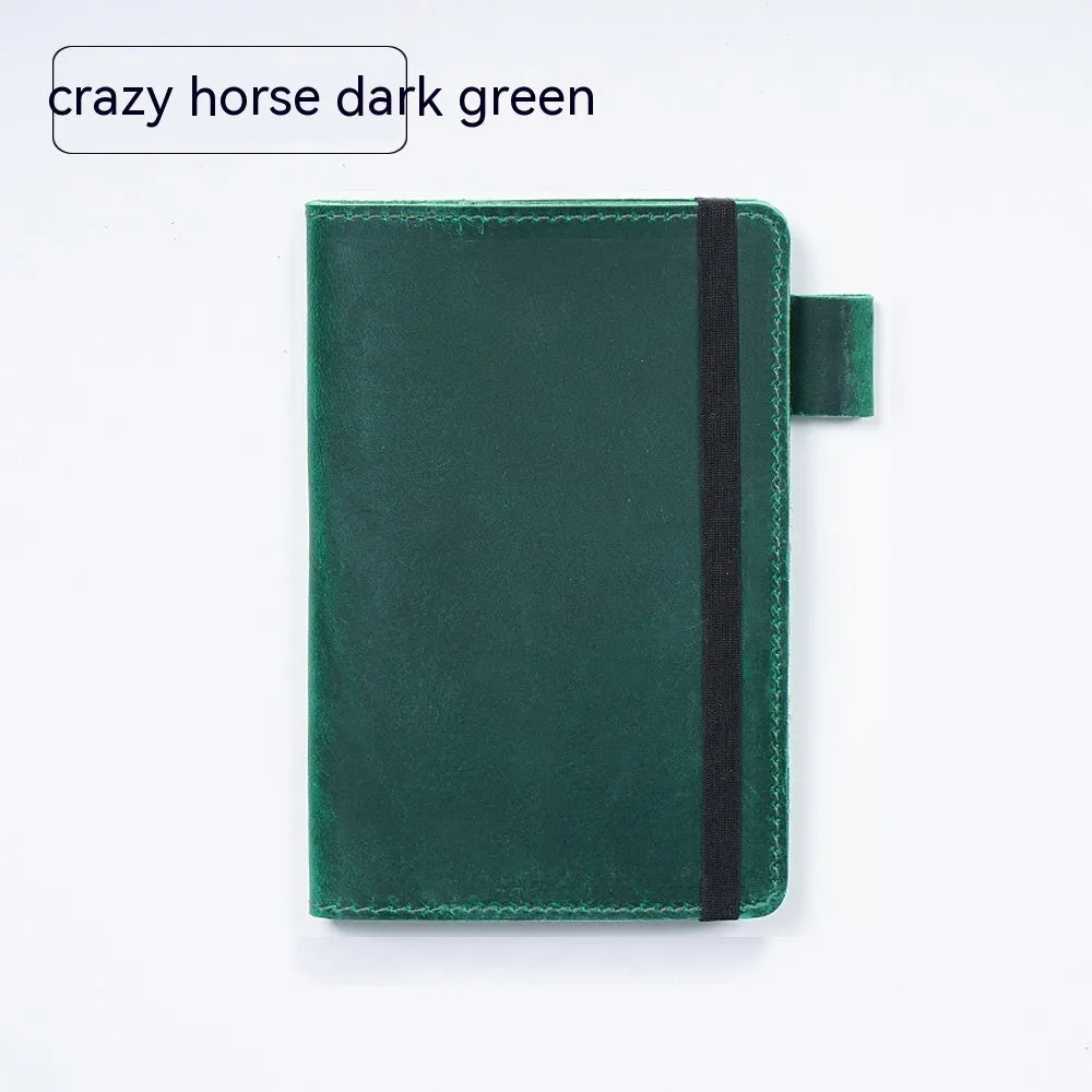 Handmade leather kraft notebook open showing wood-free paper with dark green cowhide cover