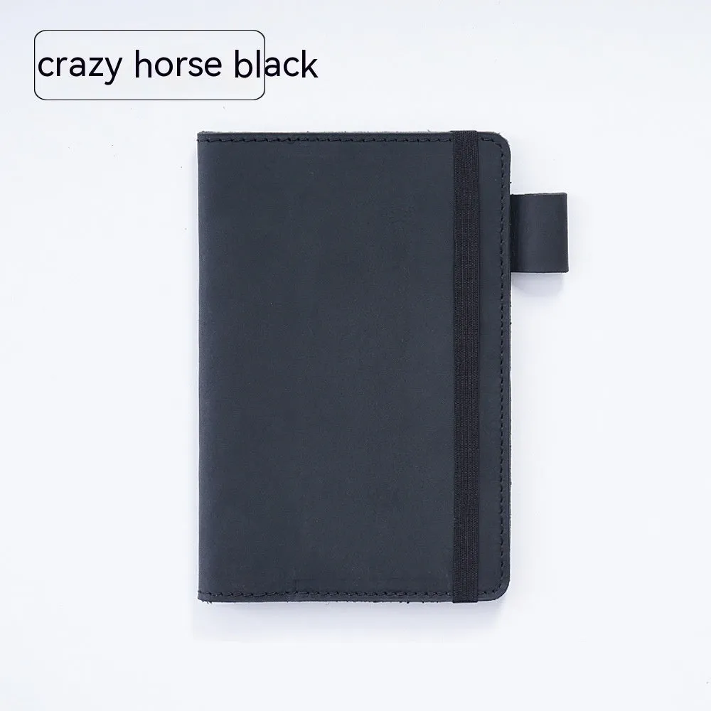 Handmade leather kraft notebook open showing wood-free paper with dark green cowhide cover