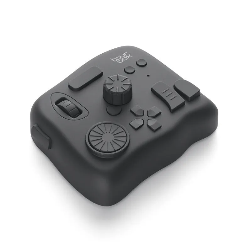 TourBox NEO black video editing controller with dials and buttons on a desk.