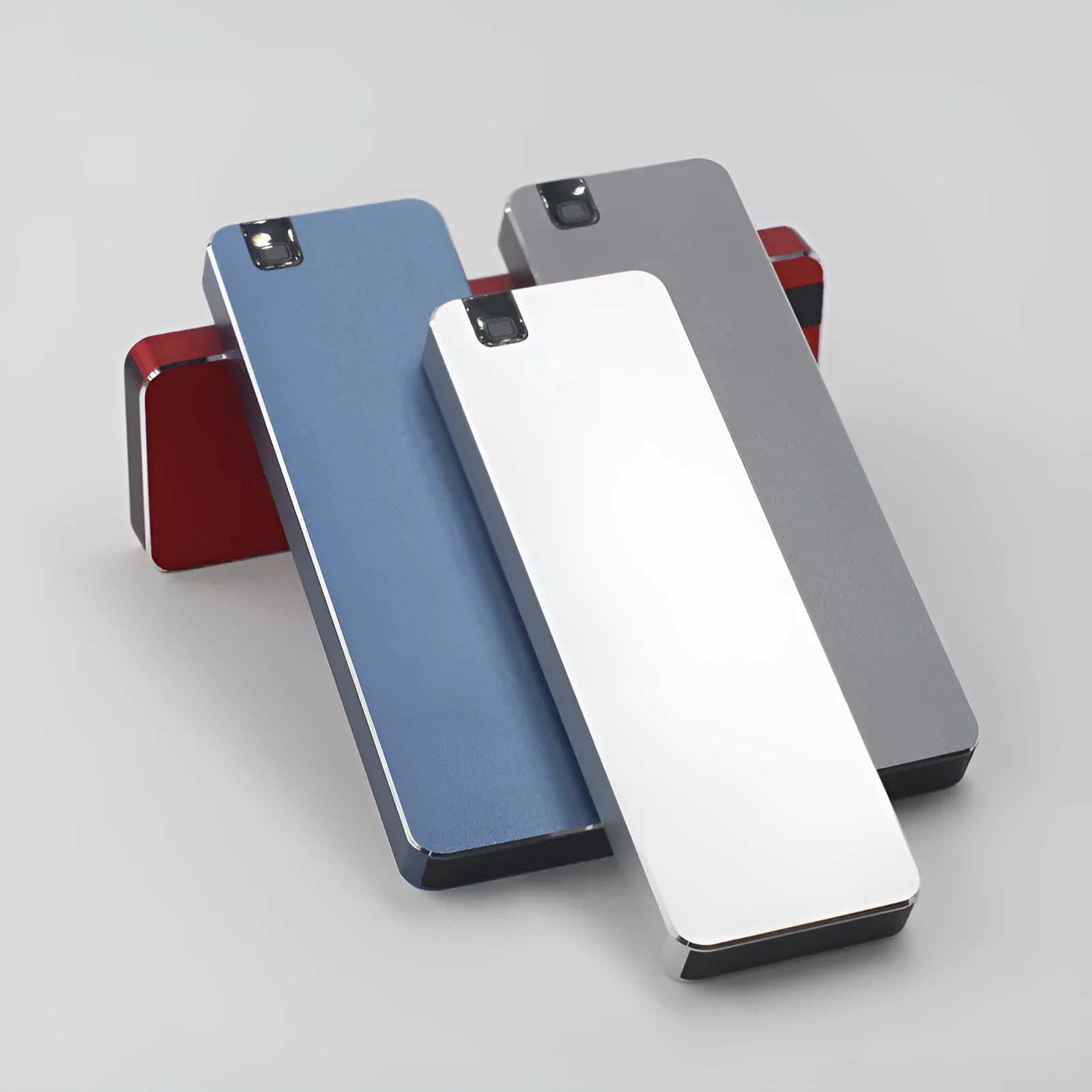 Silver portable metal-shell solid state hard drive with USB cable on a grey background.