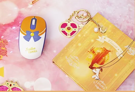 Pink Sailor Moon wireless mouse with USB receiver on a desk.