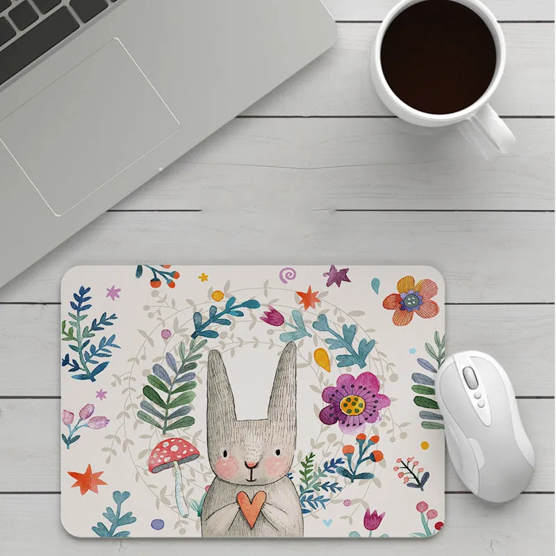 Thick custom cartoon mouse pad with colourful design on a desk, showing black seam edge