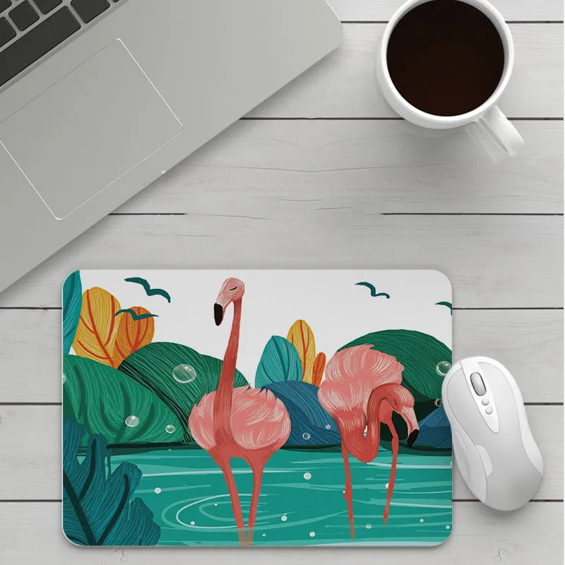 Thick custom cartoon mouse pad with colourful design on a desk, showing black seam edge