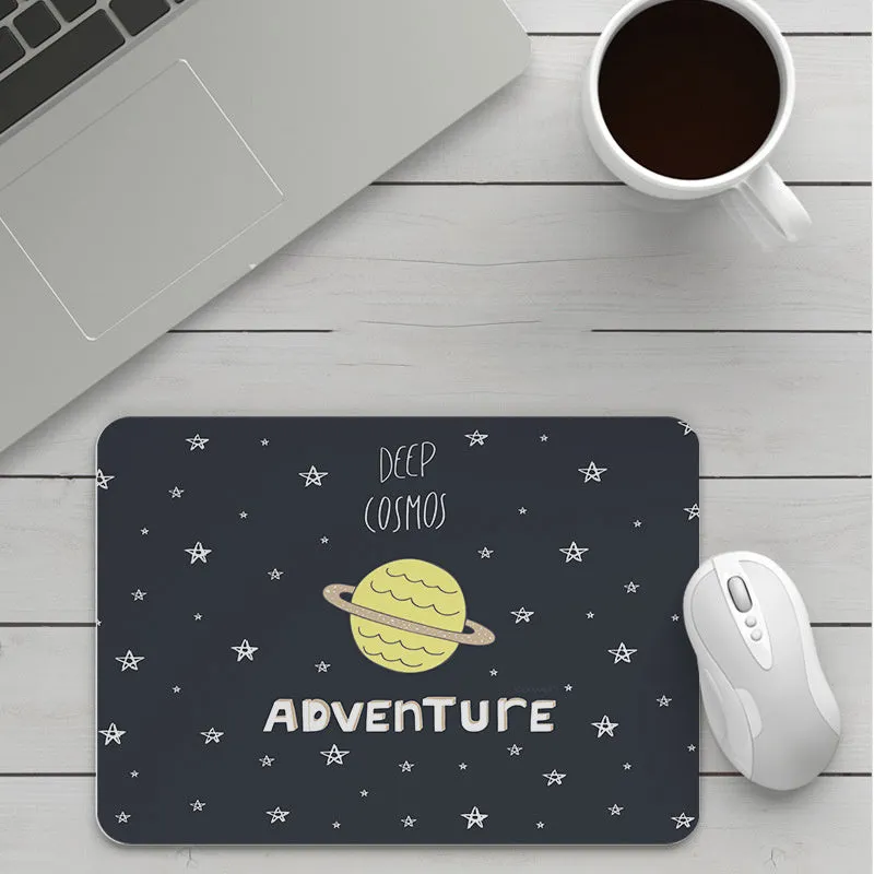 Thick custom cartoon mouse pad with colourful design on a desk, showing black seam edge