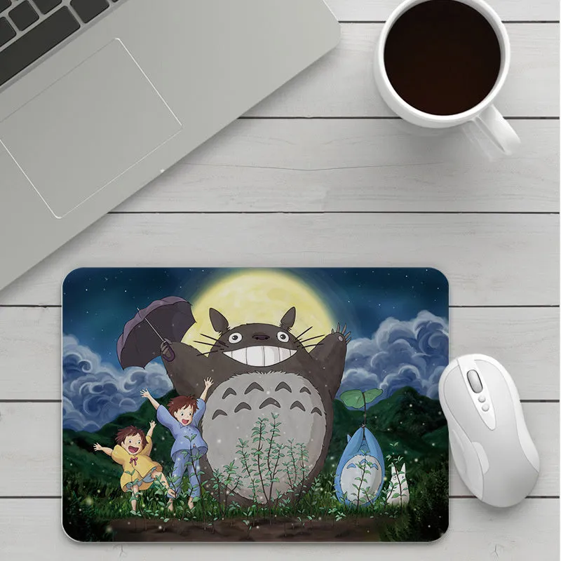 Thick custom cartoon mouse pad with colourful design on a desk, showing black seam edge
