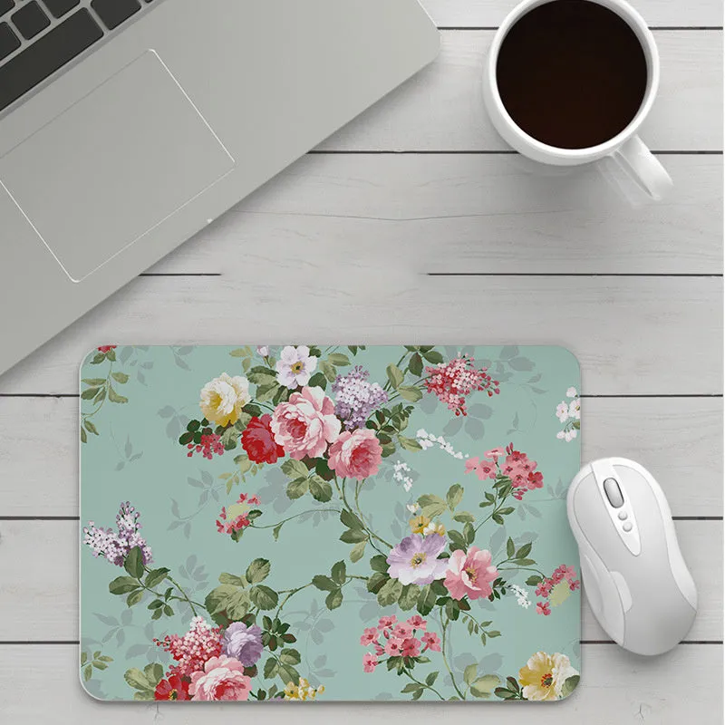 Thick custom cartoon mouse pad with colourful design on a desk, showing black seam edge