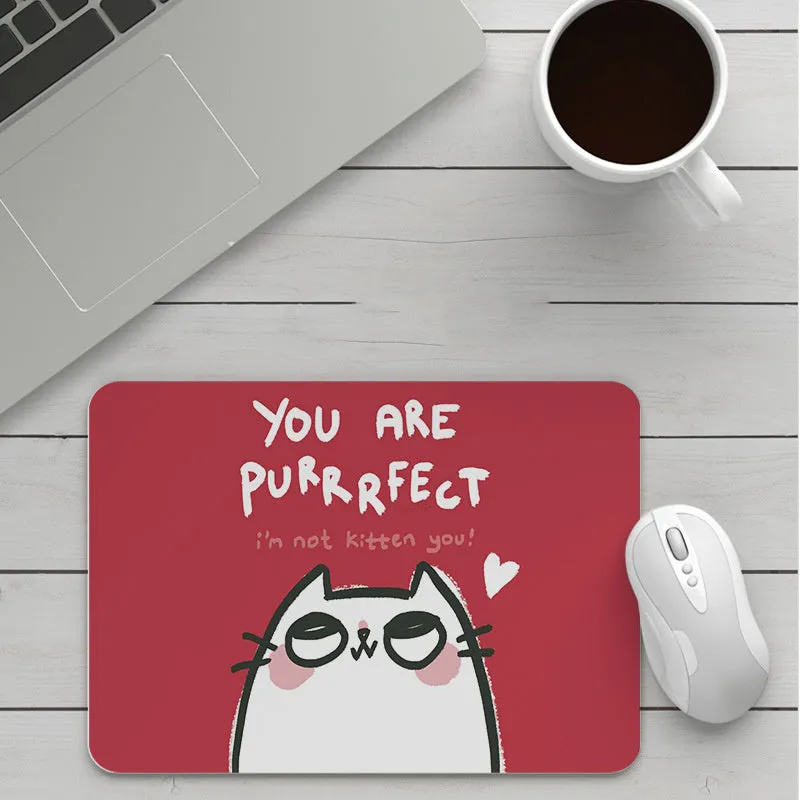 Thick custom cartoon mouse pad with colourful design on a desk, showing black seam edge