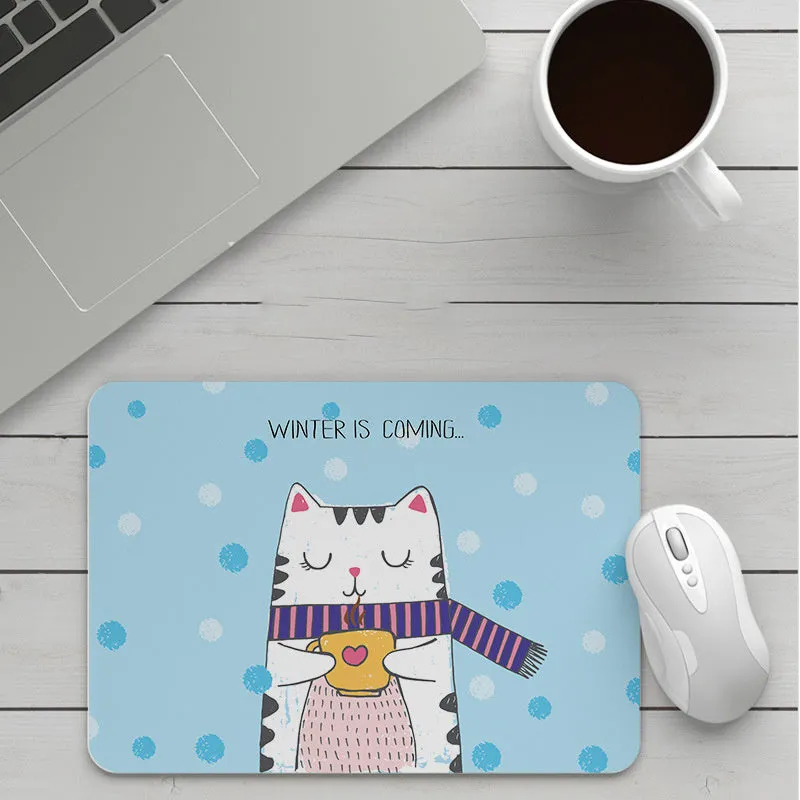 Thick custom cartoon mouse pad with colourful design on a desk, showing black seam edge