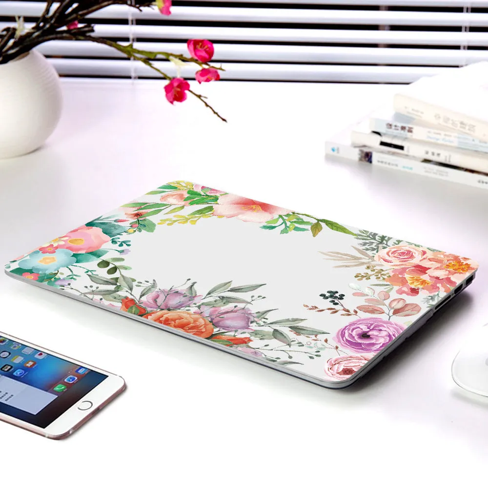 MacBook protective shell with floral pattern design covering laptop top and bottom surfaces