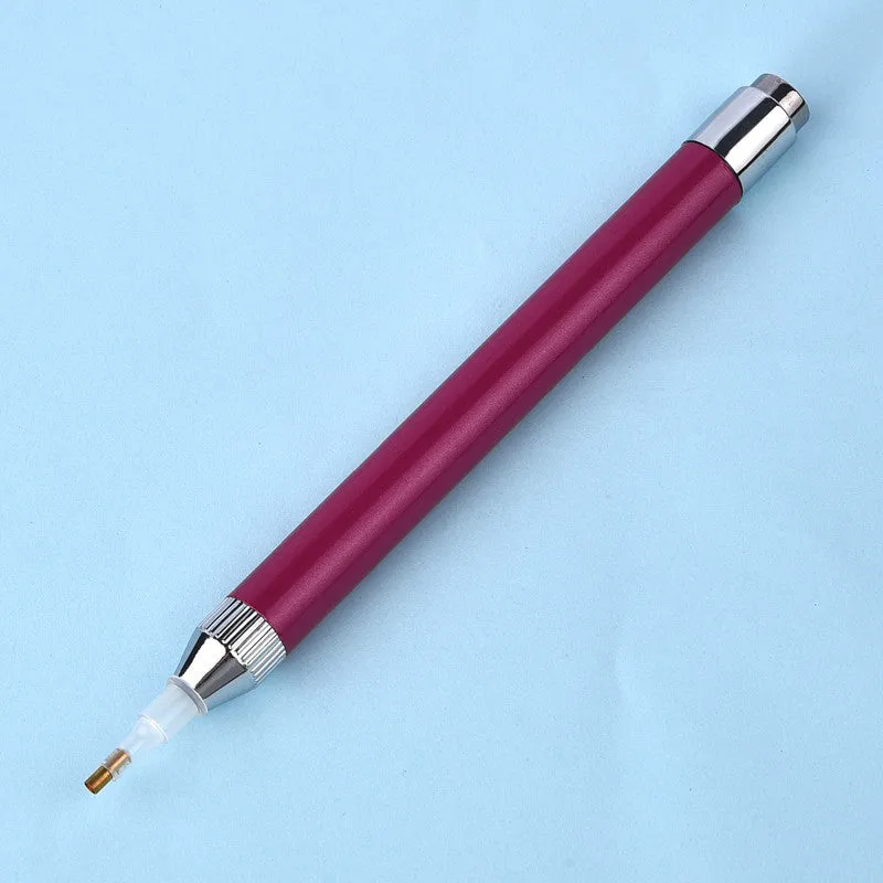 Blue luminous aluminium alloy drill pen for diamond painting and cross stitch crafts on a dark surface.