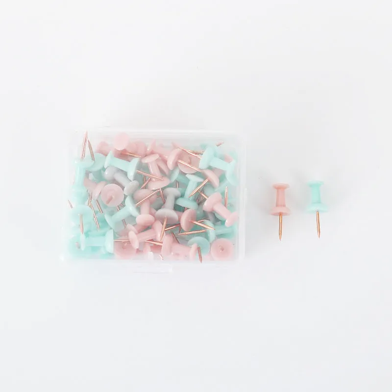 50 Morandi colour push pins with five-pointed star heads on a cork board