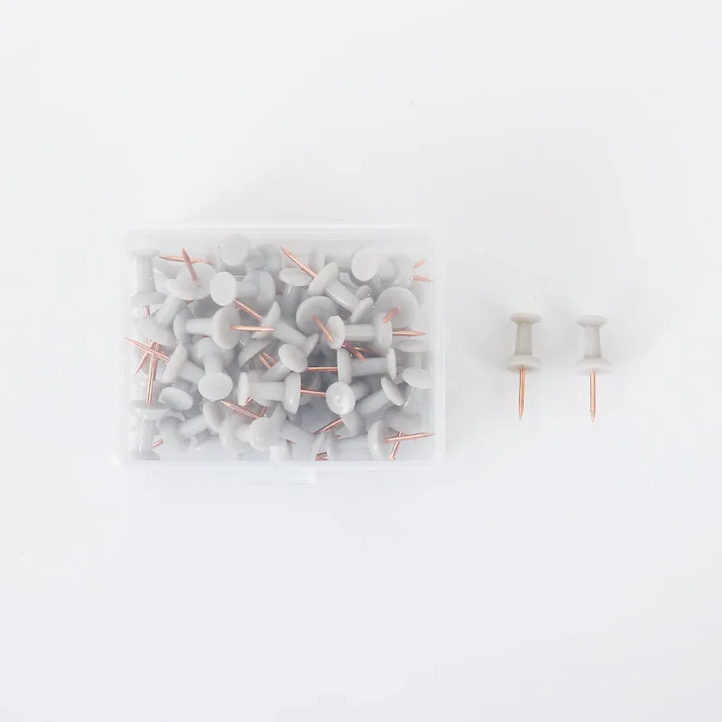 50 Morandi colour push pins with five-pointed star heads on a cork board