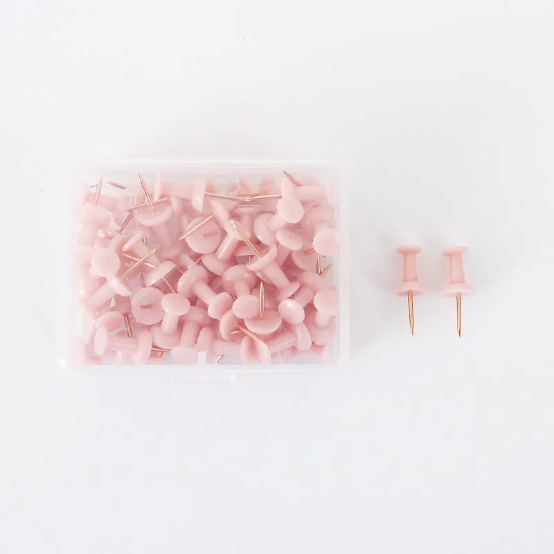 50 Morandi colour push pins with five-pointed star heads on a cork board