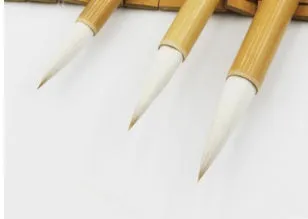 Three Chinese calligraphy brushes with bamboo handles and woolen bristles in large, medium, and small sizes