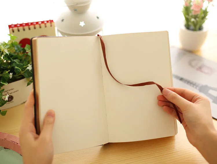 Jingu 35mm thick imitation leather notebook open on a desk.