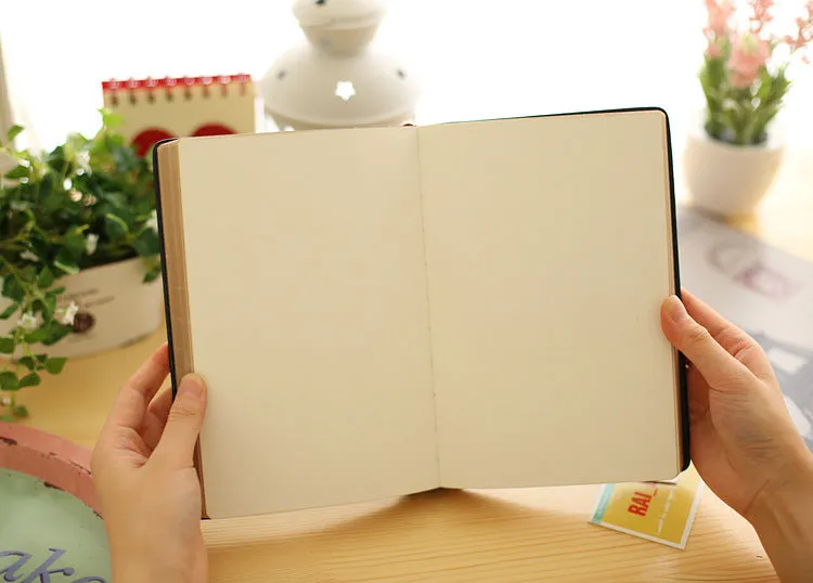Jingu 35mm thick imitation leather notebook open on a desk.