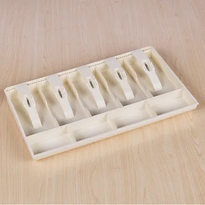 Black and white ABS plastic cash register box with five drawers for banknotes and coins.