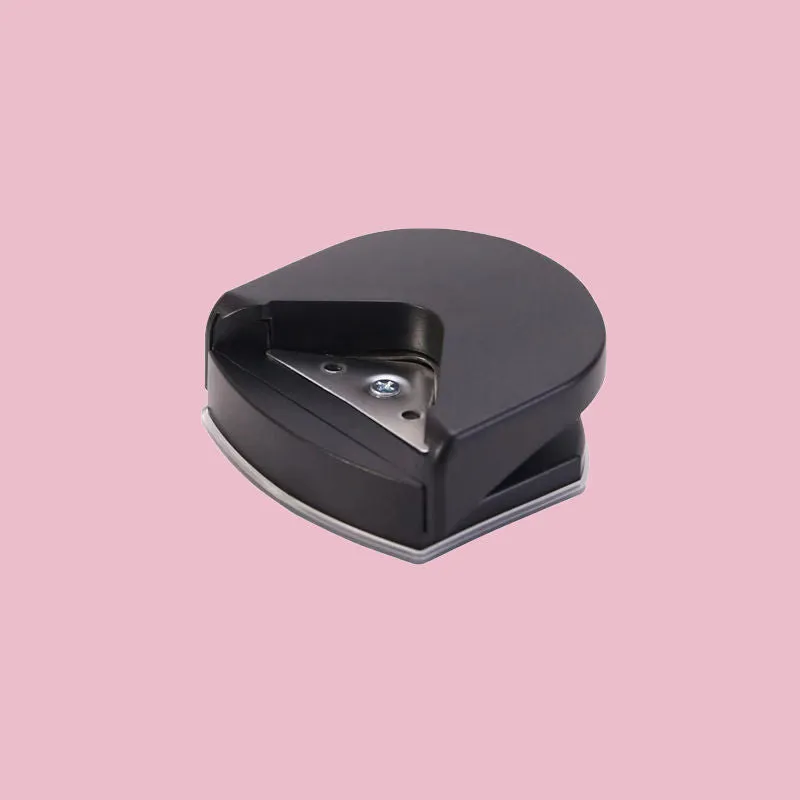Black plastic and metal business card corner cutter on a white background.