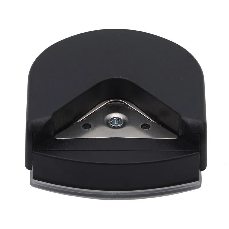 Black plastic and metal business card corner cutter on a white background.