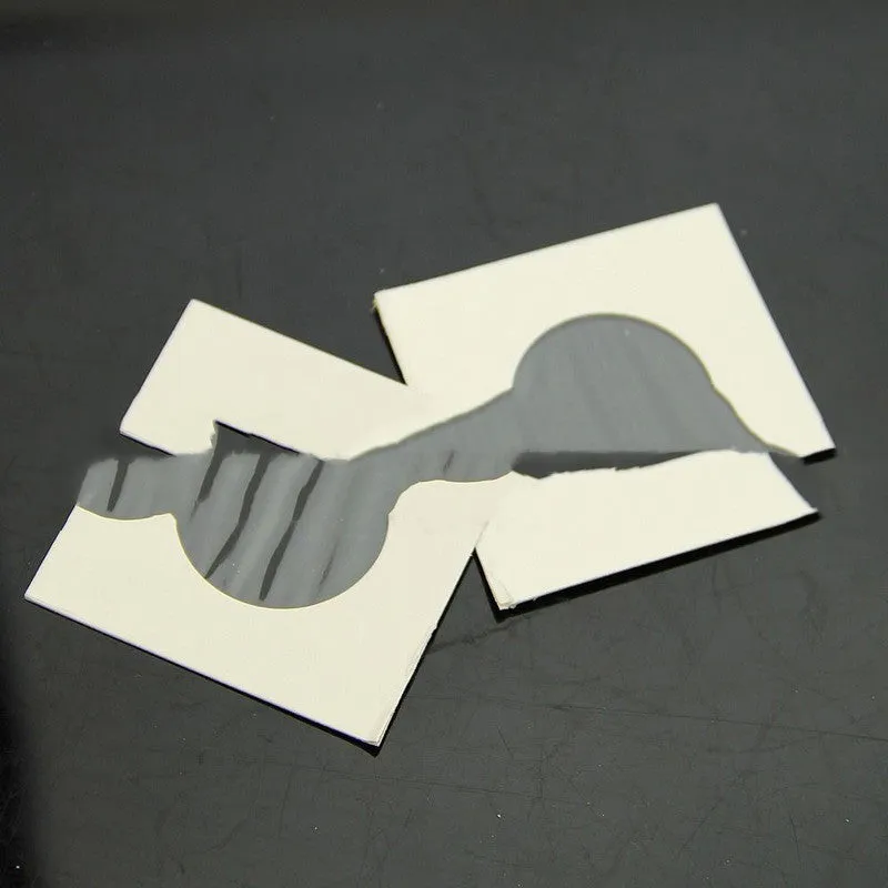 Set of 50 white paper coin protector clips for commemorative coins in a transparent OPP bag.