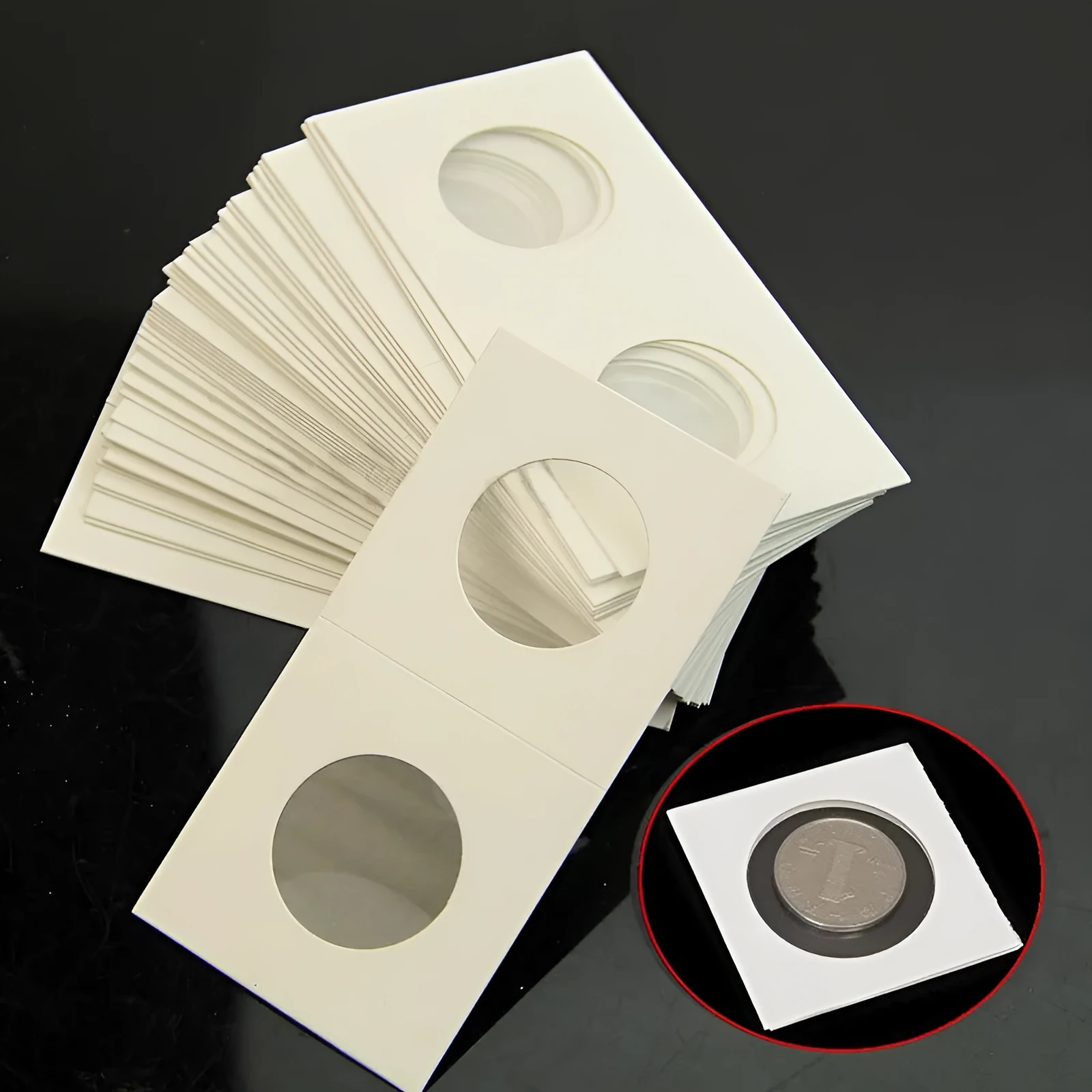 Set of 50 white paper coin protector clips for commemorative coins in a transparent OPP bag.